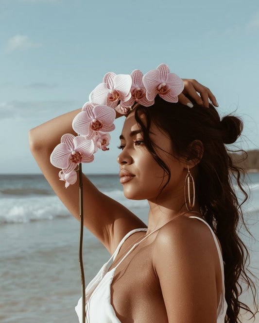 Woman with pink orchids on a beach