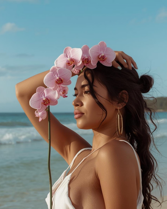 Woman with pink orchid on a beach