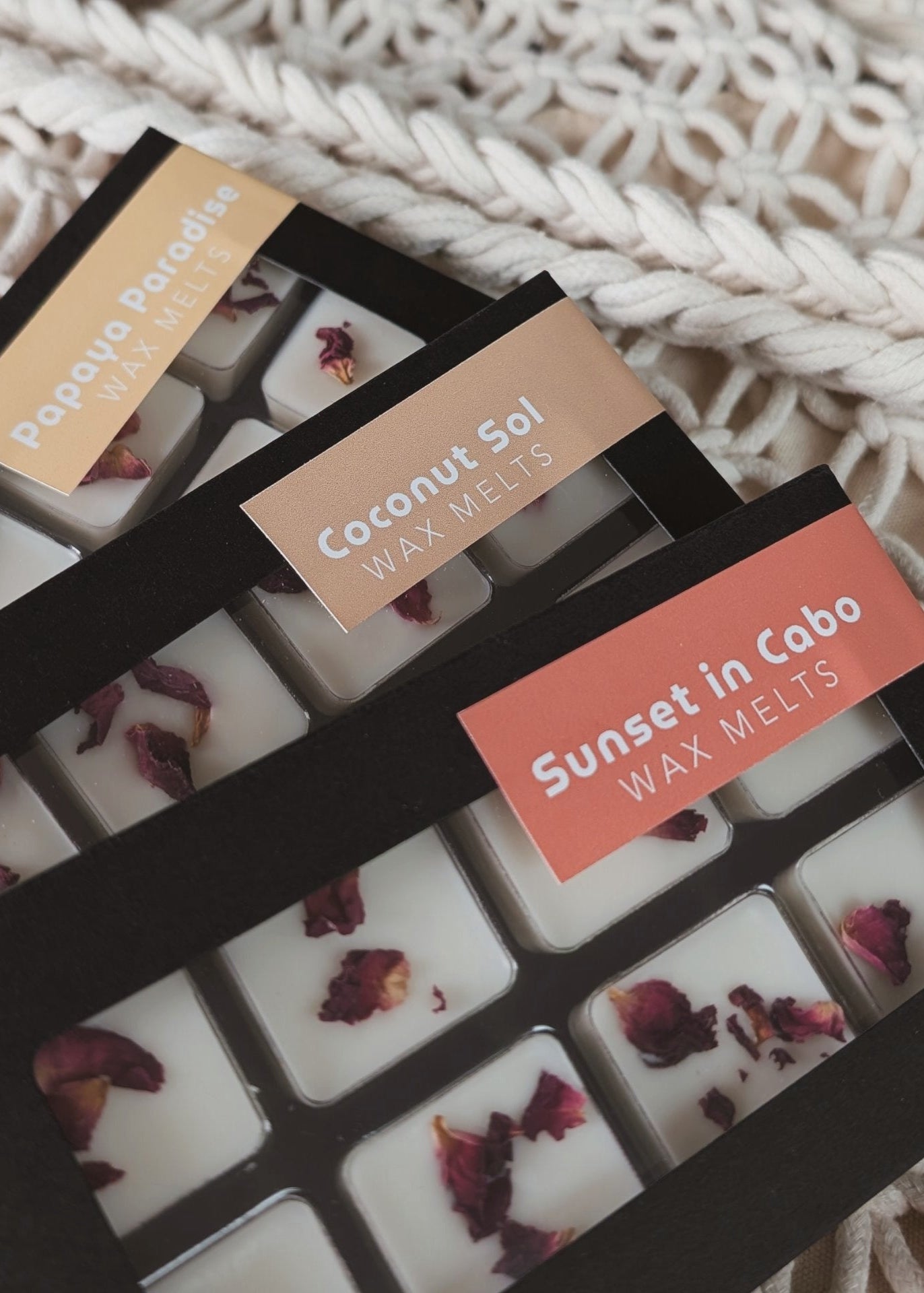 Wax melts packaging with visible labels on a textured surface