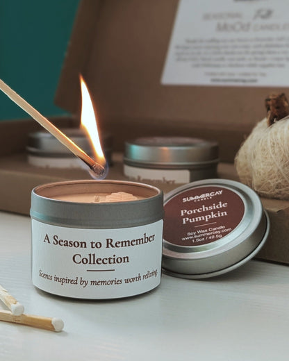 Candle being lit with a set of candles in a cardboard box in the background