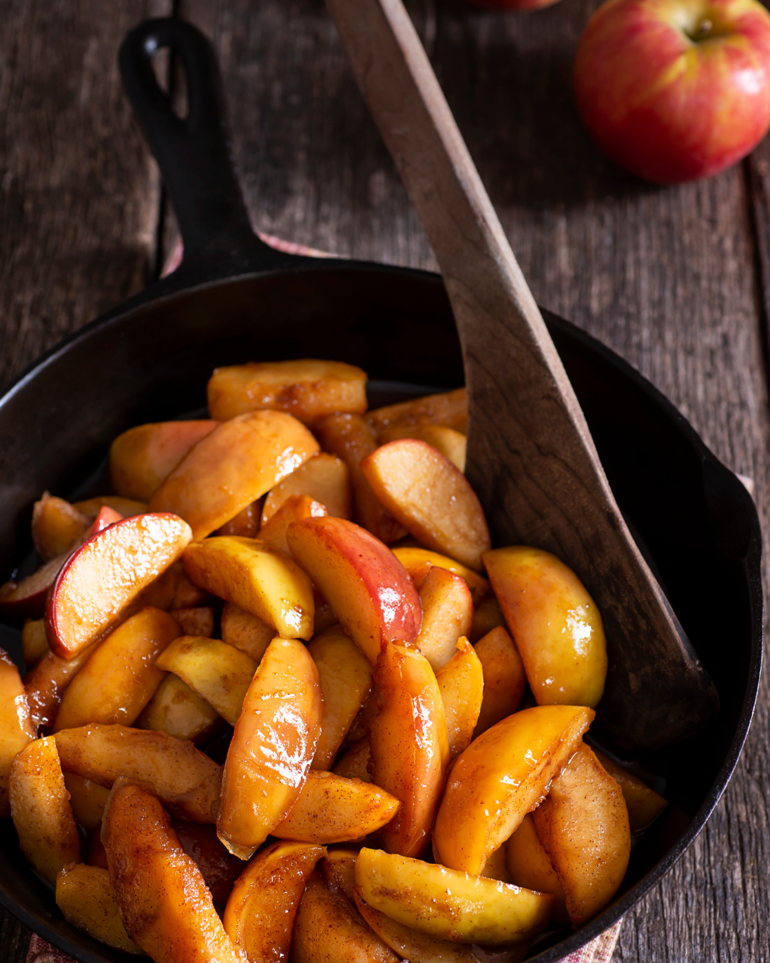 glazed apples in skillet on wood table