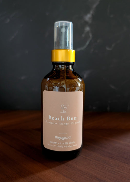 Bottle of Beach Bum hair product on a wooden surface with a dark background