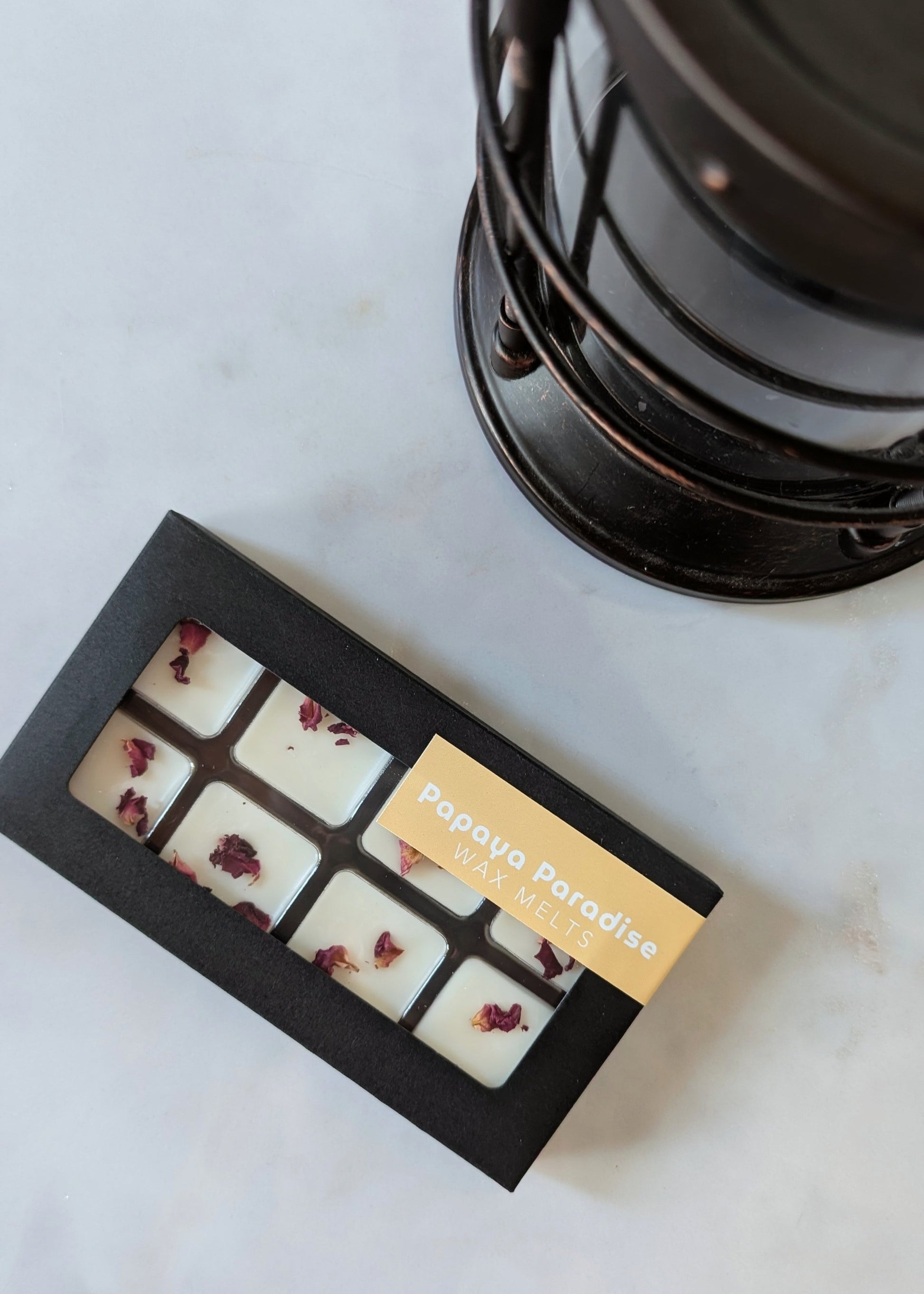 Box of Papaya Paradise wax melts next to a wax melter