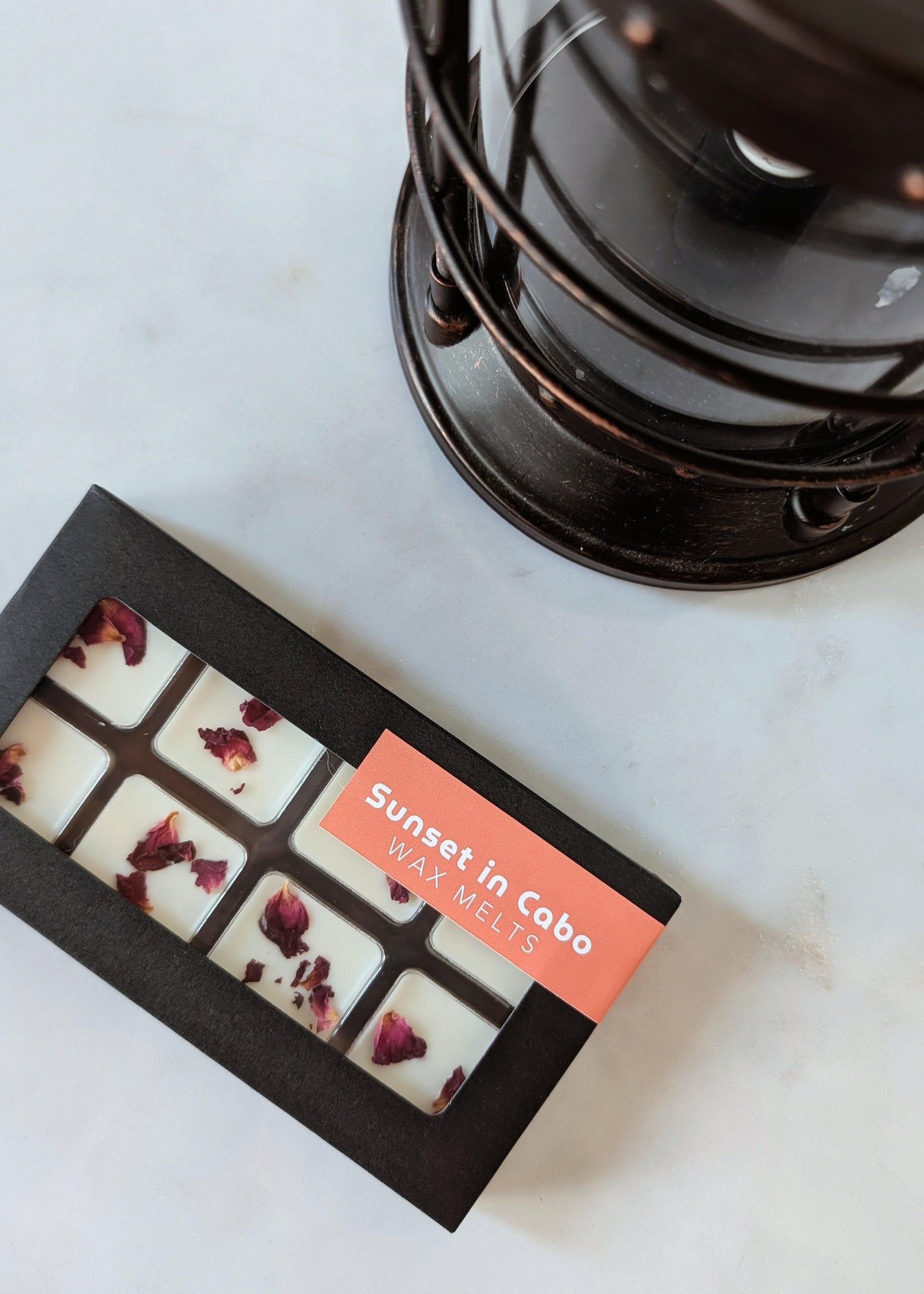 Box of 'Sunset in Cabo' wax melts next to a wax melter